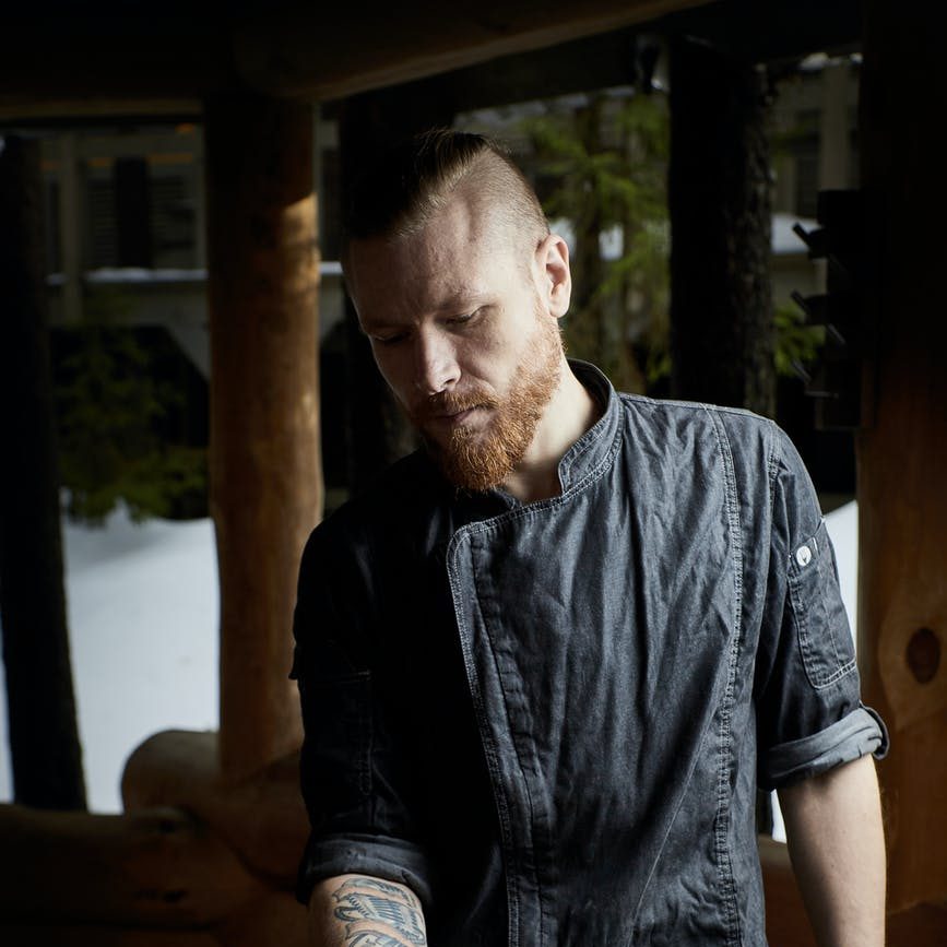man holding plate with food in room